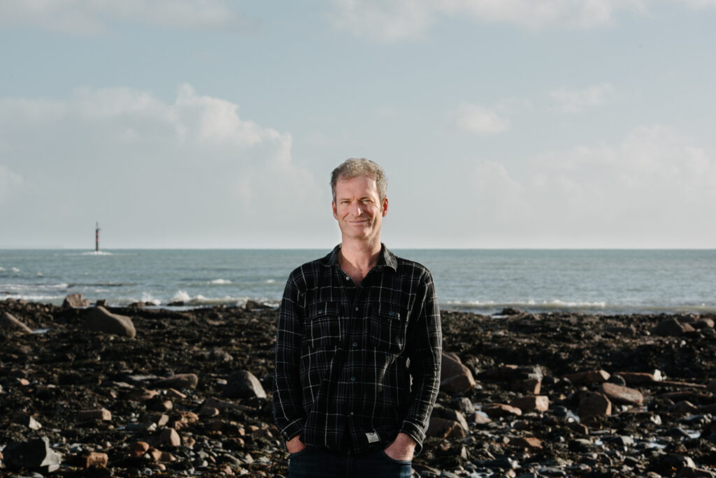 Martin from Cornish content marketing agency Coast on Penzance beach in a black shirt.